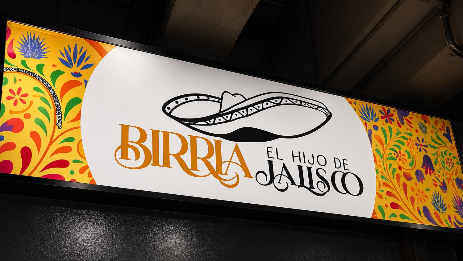 Letrero de Birria El Hijo de Jalisco bajo el puente